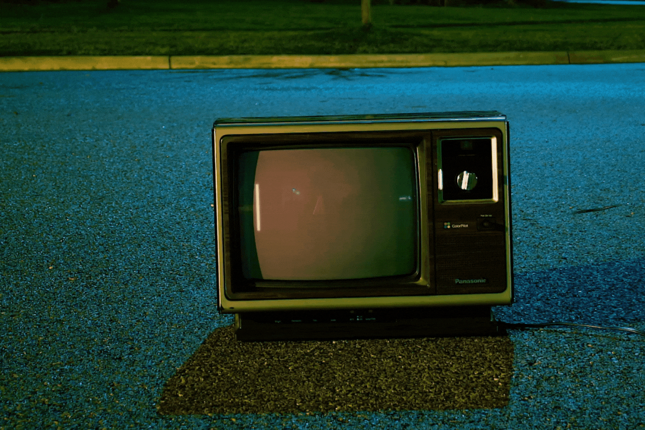 gif of old box tv sitting in the street with texts typing out "the digital store"